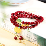 Elegant Red Sandstone Bracelet with Jade Charms