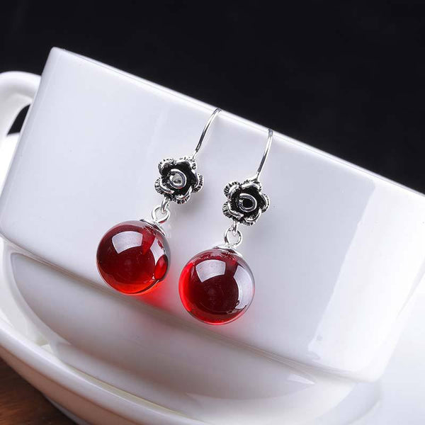 Elegant Silver Rose Earrings with Red Gem