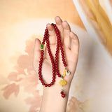 Elegant Red Sandstone Bracelet with Jade Charms