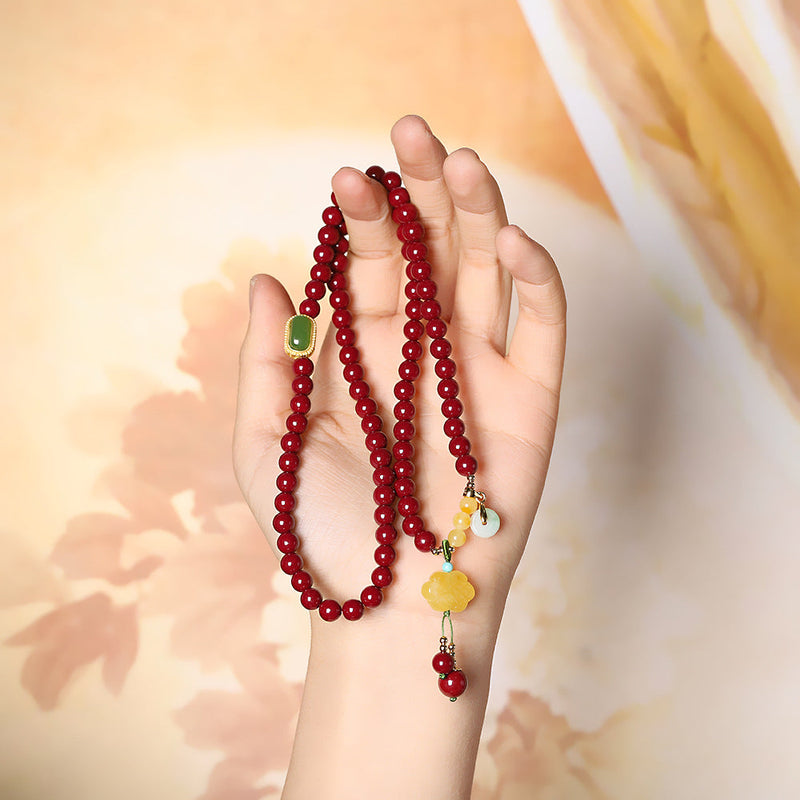 Elegant Red Sandstone Bracelet with Jade Charms